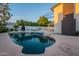 Backyard pool with a relaxing spa, exterior lights, and a cozy sitting area at 6216 W Poinsettia Dr, Glendale, AZ 85304