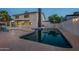 Inviting backyard pool with a smooth concrete patio and partial view of the two-story home at 6216 W Poinsettia Dr, Glendale, AZ 85304