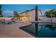 Backyard oasis featuring a pool, spa, and a spacious patio for outdoor entertainment and relaxation at 6216 W Poinsettia Dr, Glendale, AZ 85304