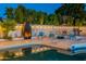Luxurious backyard pool and patio area, complete with an outdoor fireplace and ample seating at 6216 W Poinsettia Dr, Glendale, AZ 85304