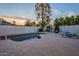 Backyard pool with a relaxing spa, exterior lights, and a brick fireplace at 6216 W Poinsettia Dr, Glendale, AZ 85304