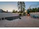 Sparkling pool area featuring a fire pit, lounge chairs, and string lights, creating a relaxing outdoor oasis at 6216 W Poinsettia Dr, Glendale, AZ 85304