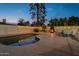 Backyard pool with spa and a cozy fireplace, creating a relaxing oasis for year-round enjoyment at 6216 W Poinsettia Dr, Glendale, AZ 85304