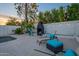Inviting pool patio with a charming fireplace and comfortable lounge chairs offers an outdoor retreat at 6216 W Poinsettia Dr, Glendale, AZ 85304
