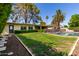 The home features a grassy backyard with a pool, privacy hedge, mature landscaping, and easy access to the house at 709 E Hayward Ave, Phoenix, AZ 85020