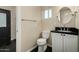 Bathroom featuring a black vanity, toilet, mirror and lighting at 709 E Hayward Ave, Phoenix, AZ 85020