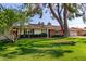 Charming single story home with a well-manicured lawn and mature landscaping surrounding the home at 709 E Hayward Ave, Phoenix, AZ 85020