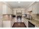 Well-lit kitchen featuring granite countertops, stainless steel appliances and wood flooring at 709 E Hayward Ave, Phoenix, AZ 85020
