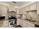 Kitchen features granite counters, tile backsplash, stainless steel appliances, and custom cabinets at 709 E Hayward Ave, Phoenix, AZ 85020