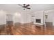 Spacious living room with hardwood floors, fireplace, and a ceiling fan at 709 E Hayward Ave, Phoenix, AZ 85020