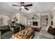 Bright living room featuring hardwood floors, fireplace, neutral paint and a ceiling fan at 709 E Hayward Ave, Phoenix, AZ 85020