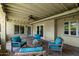 Covered outdoor patio with brick flooring and comfortable seating creating an inviting spot for relaxation and entertaining at 709 E Hayward Ave, Phoenix, AZ 85020