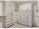 Walk-in closet featuring custom shelving and drawers for optimal storage and organization at 709 E Hayward Ave, Phoenix, AZ 85020