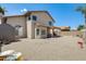 View of the backyard with neutral rocks and a covered patio at 720 W Palo Verde St, Gilbert, AZ 85233