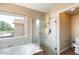 Bright bathroom featuring a soaking tub, and a separate glass-enclosed shower and toilet at 720 W Palo Verde St, Gilbert, AZ 85233