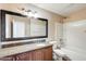 This bathroom features a vanity with a granite countertop and a shower-tub combination at 720 W Palo Verde St, Gilbert, AZ 85233