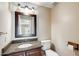 Well-maintained bathroom with a granite countertop, framed mirror, and toilet for convenience at 720 W Palo Verde St, Gilbert, AZ 85233