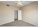 Comfortable bedroom with neutral carpet, a ceiling fan, and a door, creating a relaxing atmosphere at 720 W Palo Verde St, Gilbert, AZ 85233