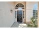 View of the black front door with arched window and desert landscaping at 720 W Palo Verde St, Gilbert, AZ 85233