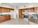 Well-lit kitchen boasts beautiful wood cabinetry, modern appliances, and tiled floor at 720 W Palo Verde St, Gilbert, AZ 85233