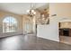 Spacious living room with an arched window, staircase, and view into the kitchen at 720 W Palo Verde St, Gilbert, AZ 85233