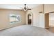 Large main bedroom with vaulted ceiling, carpeted floors, and an ensuite bathroom entrance at 720 W Palo Verde St, Gilbert, AZ 85233