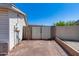 Enclosed backyard featuring a block wall, access gate and low maintenance desert landscaping at 7210 W Caron Dr, Peoria, AZ 85345