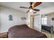 Cozy bedroom featuring a ceiling fan, sliding closet, and soft lighting at 7210 W Caron Dr, Peoria, AZ 85345