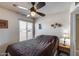 Bedroom featuring a ceiling fan, a window, and neutral-colored walls at 7210 W Caron Dr, Peoria, AZ 85345
