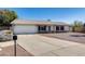 Charming single-story home with a two-car garage and low maintenance landscaping at 7210 W Caron Dr, Peoria, AZ 85345