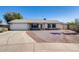 Charming single-story home with a two-car garage and low maintenance landscaping at 7210 W Caron Dr, Peoria, AZ 85345