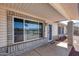 Exterior shot of the house showing the covered front porch and large window and secure entry door at 7210 W Caron Dr, Peoria, AZ 85345
