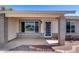 Charming front porch of home featuring decorative brick pillars, large windows, and secure entry at 7210 W Caron Dr, Peoria, AZ 85345