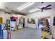 Shows a large garage with an organized workspace, storage space, and good lighting at 7210 W Caron Dr, Peoria, AZ 85345