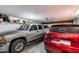 Spacious two-car garage with ample storage, featuring two vehicles at 7210 W Caron Dr, Peoria, AZ 85345
