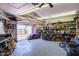 The photo shows the garage door opening and contains an organized workspace at 7210 W Caron Dr, Peoria, AZ 85345
