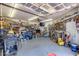 Image shows a full garage that is well lit with an organized workspace at 7210 W Caron Dr, Peoria, AZ 85345