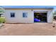 View of a garage with two windows and an open garage door, showing ample storage space at 7210 W Caron Dr, Peoria, AZ 85345