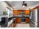 Updated kitchen with stainless steel appliances, granite countertops, and wood cabinets at 7210 W Caron Dr, Peoria, AZ 85345