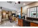 Open-concept design with a view of the living room and granite countertops with wood cabinets at 7210 W Caron Dr, Peoria, AZ 85345