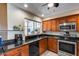 A charming kitchen boasts wood cabinets, granite countertops, and stainless steel appliances at 7210 W Caron Dr, Peoria, AZ 85345