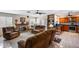 Bright, open-concept living room with brick fireplace and view into modern kitchen at 7210 W Caron Dr, Peoria, AZ 85345