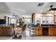Open-concept living and kitchen area featuring a ceiling fan and tile floors at 7210 W Caron Dr, Peoria, AZ 85345