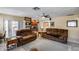 Spacious living room with comfortable seating, neutral carpeting, and an open kitchen concept at 7210 W Caron Dr, Peoria, AZ 85345