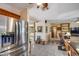 Open floor plan with stainless steel refrigerator and view of the cozy living room at 7210 W Caron Dr, Peoria, AZ 85345