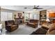 Cozy living room featuring a brick fireplace, comfortable seating and tile flooring at 7210 W Caron Dr, Peoria, AZ 85345