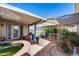 Covered patio with stone flooring, a built-in pond, and outdoor seating at 7210 W Caron Dr, Peoria, AZ 85345