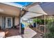 Covered patio featuring stone flooring, a table, chairs, and an exit door at 7210 W Caron Dr, Peoria, AZ 85345