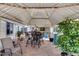 Back patio includes stone flooring, a table and chairs, and yard views at 7210 W Caron Dr, Peoria, AZ 85345