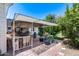 Covered patio featuring stone flooring, a table and chairs, and beautiful plants at 7210 W Caron Dr, Peoria, AZ 85345